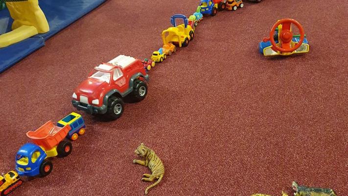Photo showing toy trucks lined up like a traffic jam